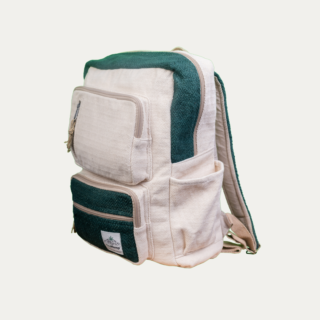 Handmade off-white hemp backpack with multiple pockets and green accents, shown from the side.