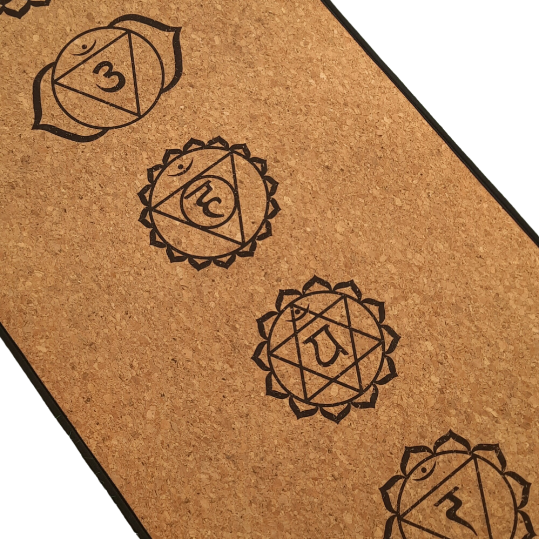 Eco-friendly cork yoga mat with chakra symbols, offering excellent grip and durability for a balanced practice.