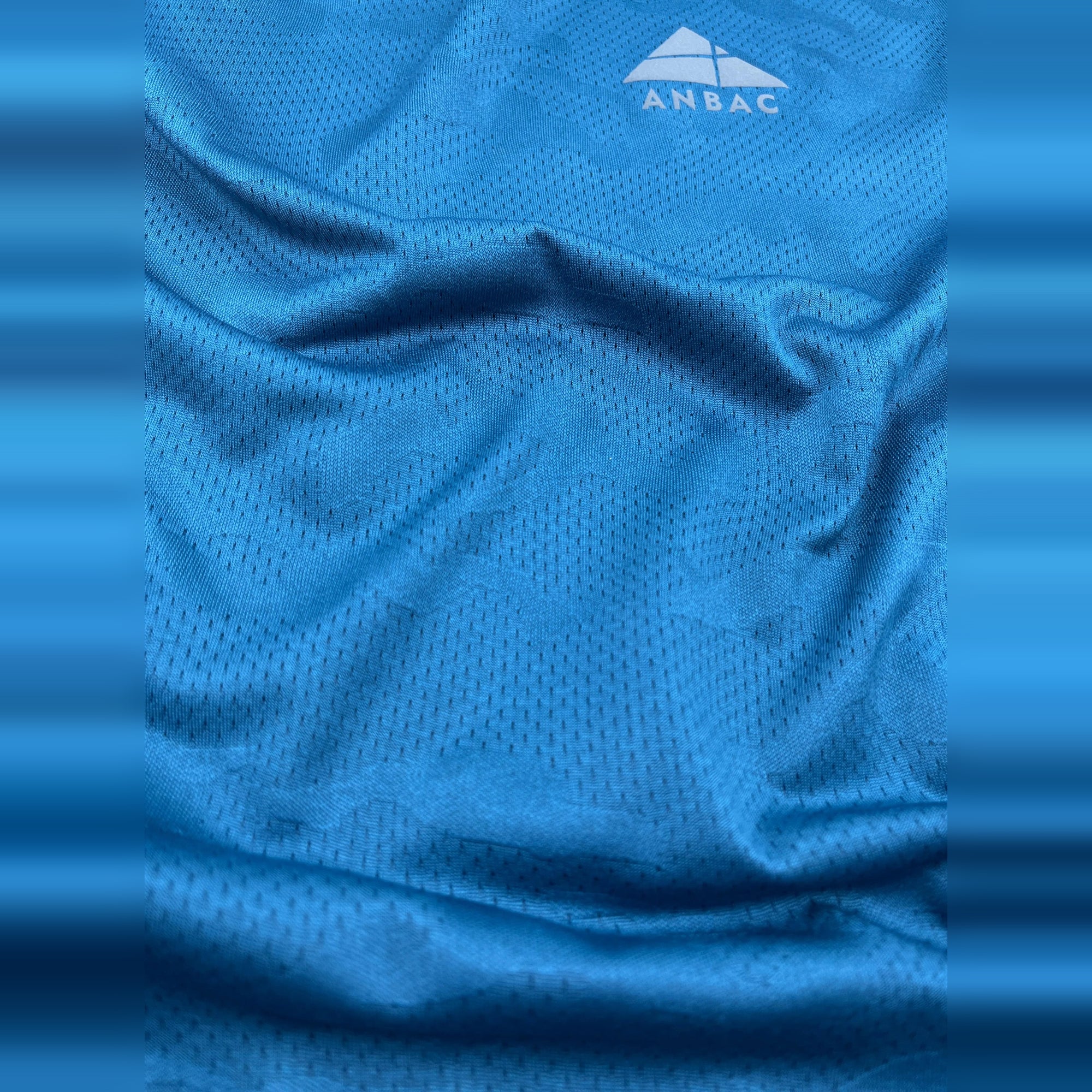 Close-up of breathable blue fabric of a men's dry-fit workout t-shirt.