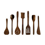 Set of seven handmade wooden kitchen utensils including spatulas, spoons, and a slotted spoon, arranged on a white background.