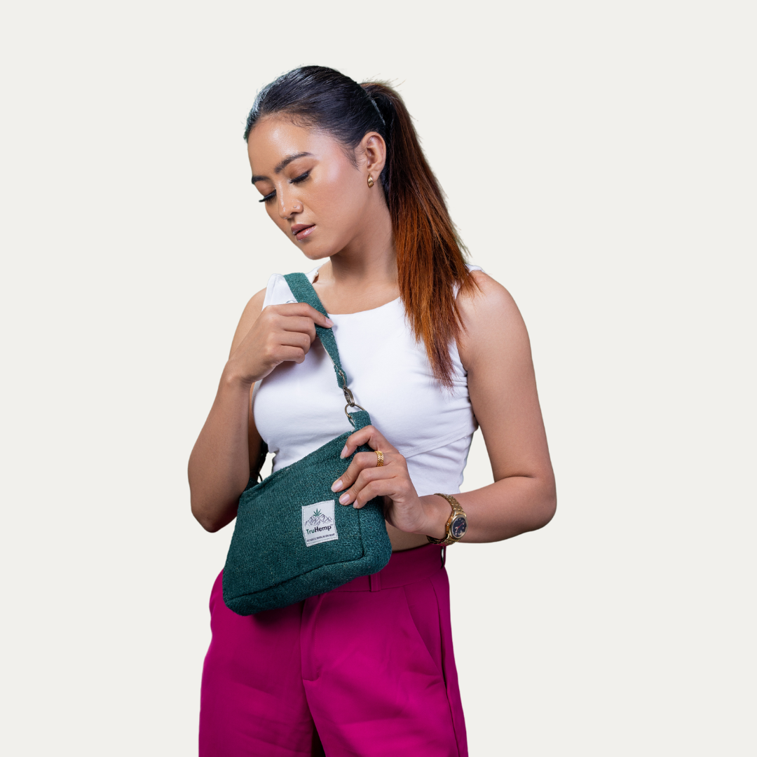 A woman models a stylish green hemp sling shoulder bag, perfect for eco-conscious women seeking a sustainable and fashionable accessory.