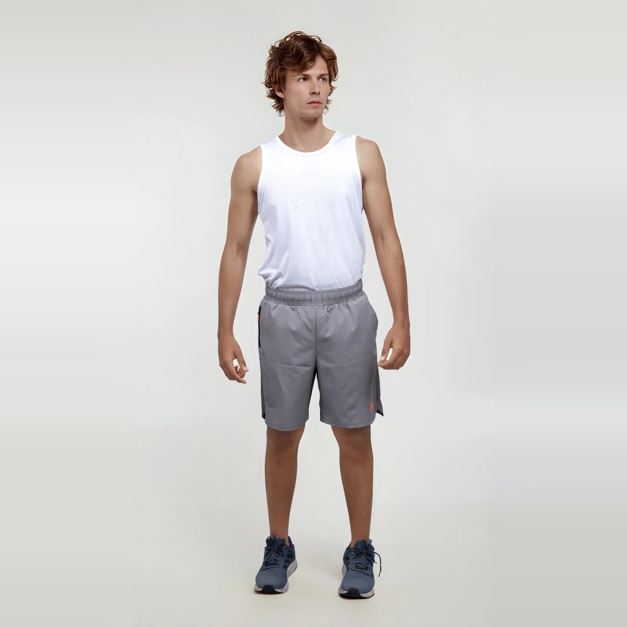 Man wearing wrinkle-free, dry-fit, regular fit gray shorts for sports and gym.