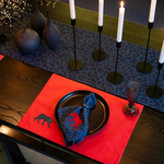 Elegant red placemat and blue leopard-print napkin with embroidered animal silhouettes, part of the Royal Walk dining set.