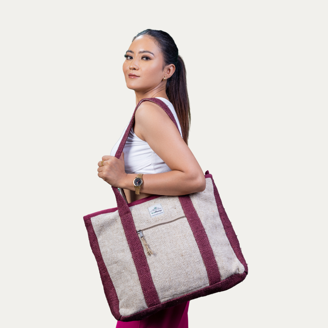 A woman models a spacious, eco-friendly hemp tote bag with maroon accents, perfect for corporate settings or everyday use.