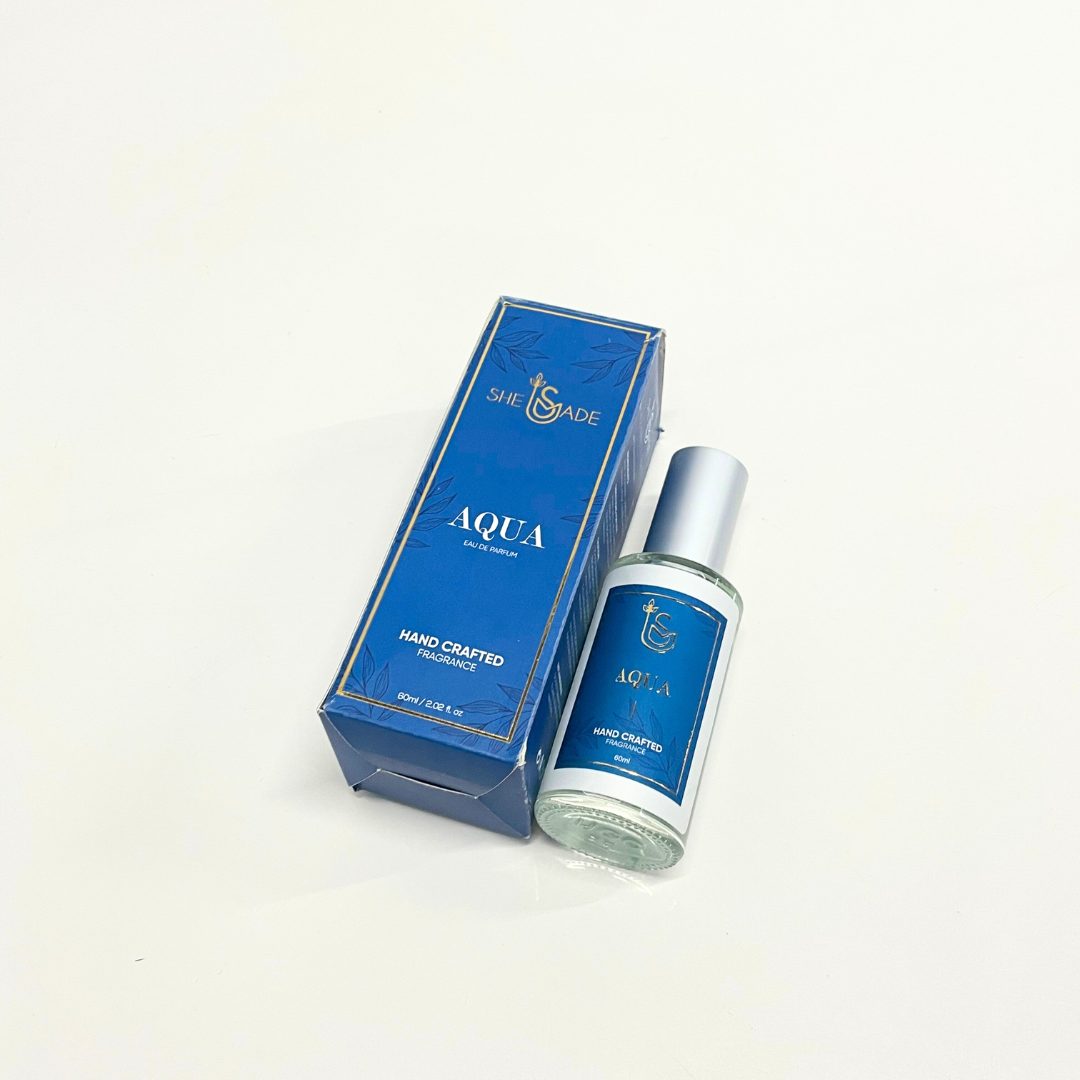 A bottle of The Aquanautical Perfume, a unisex fragrance by She is Made, displayed with its blue and white packaging.