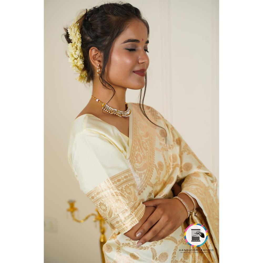 Woman wearing a Parmigiano Cheese color Banarasi tissue silk saree with intricate gold paisley designs.