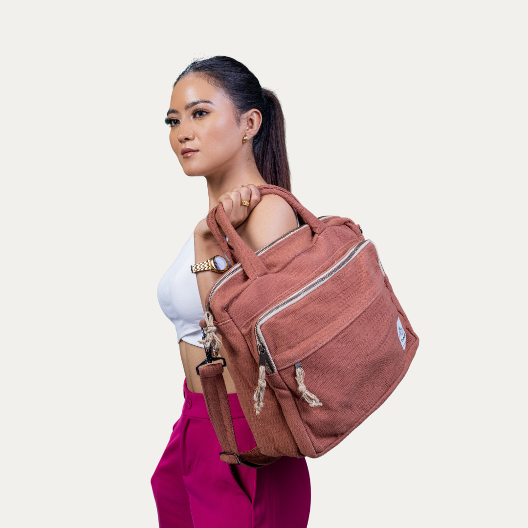 Stylish woman carrying a rust-colored "Handmade Natural Hemp Side Bag with Cotton Blend," perfect for eco-conscious individuals.