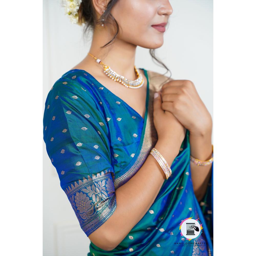 Elegant woman in a blue and teal Banarasi tissue silk saree with intricate printed patterns. Perfect for special occasions.