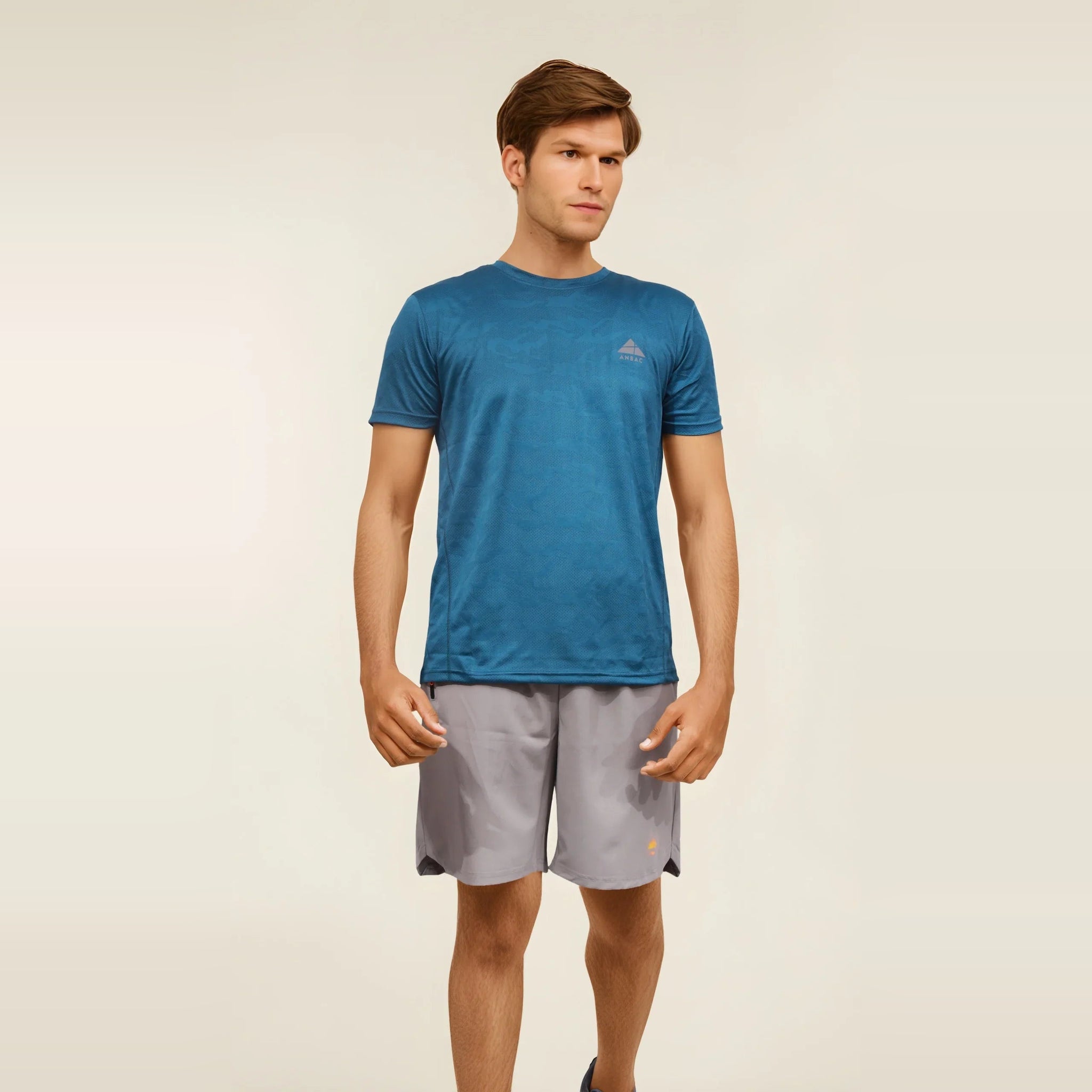 Man wearing a blue Dry-Fit crew neck T-shirt, ideal for workouts and staying cool during exercise.