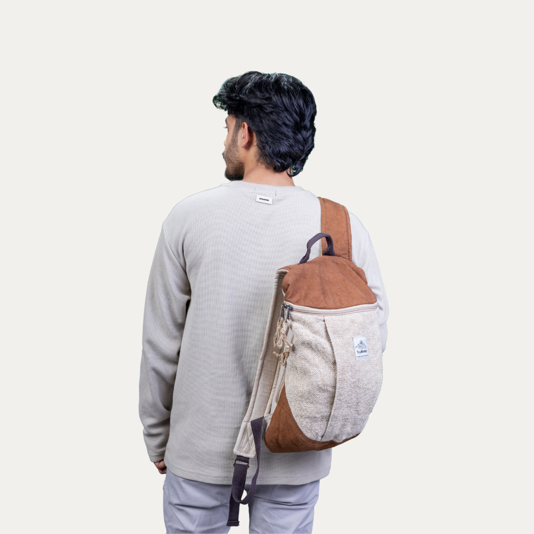 Man wearing a handcrafted hemp backpack with a pure cotton lining. This eco-friendly backpack is perfect for everyday use.