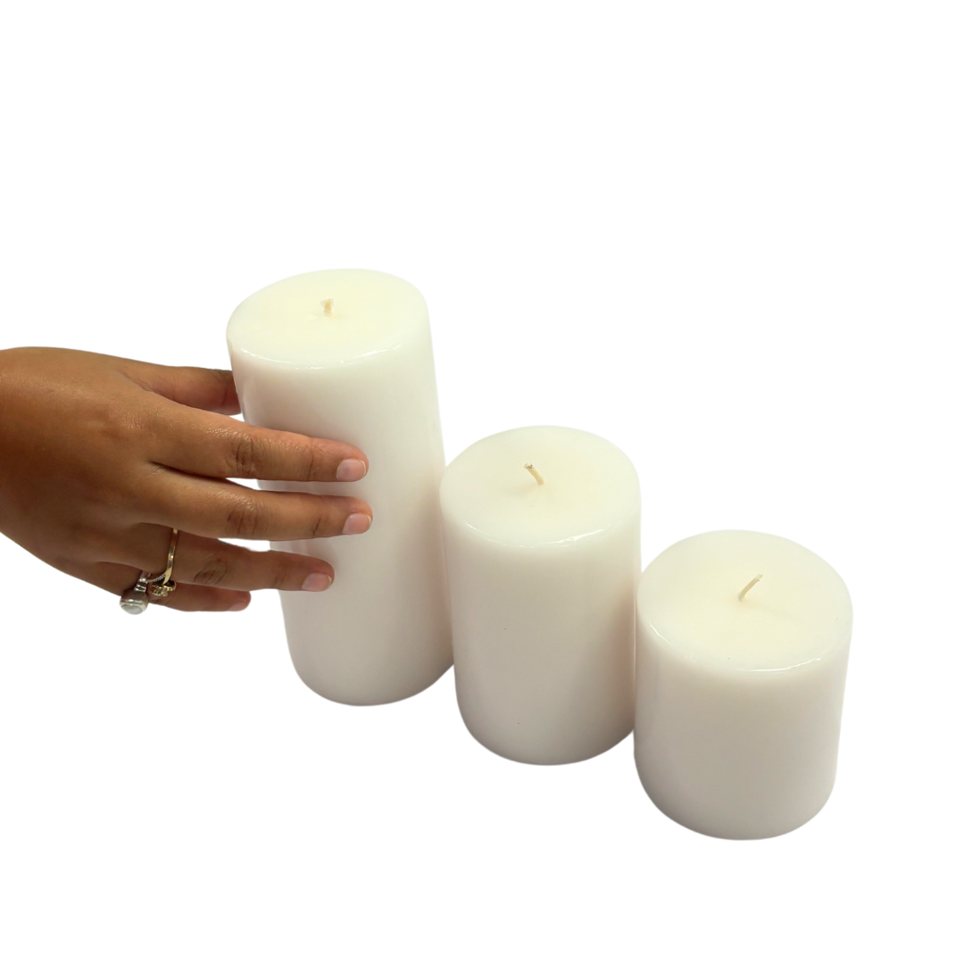 Set of three unscented white pillar candles in varying sizes. Perfect for a minimalist Scandinavian aesthetic.