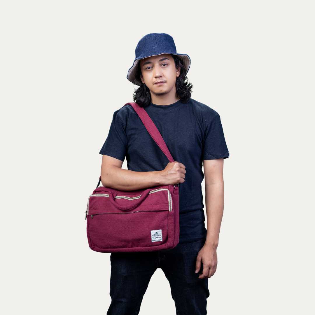 Stylish maroon hemp side bag with cotton blend, carried by a model. Perfect for eco-conscious individuals who value handmade, natural products.