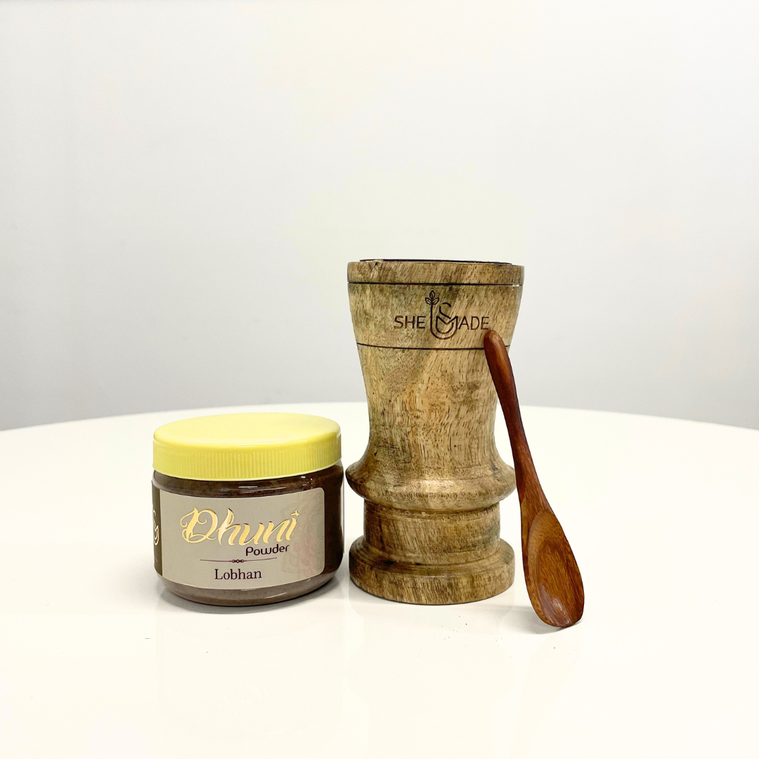 Jar of Lobhan Dhuni Powder with a wooden dhuni burner and spoon, ideal for traditional incense rituals.