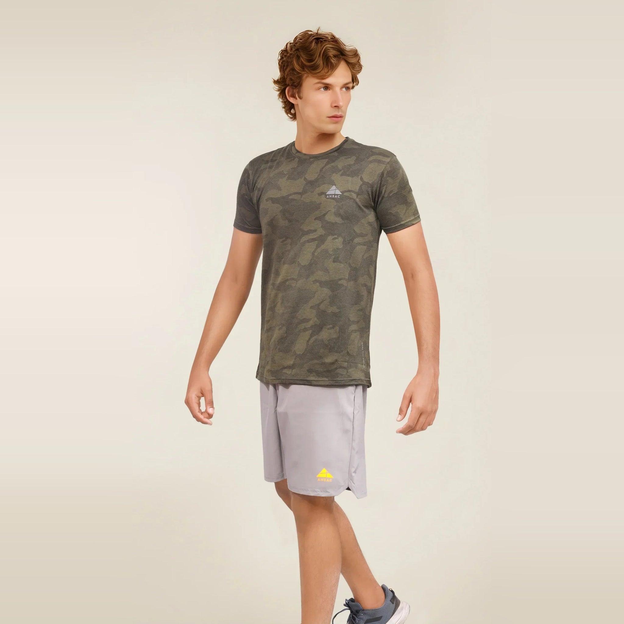 Man wearing a green camouflage dry-fit crew neck t-shirt ideal for workouts.