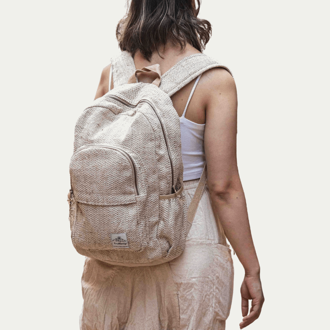 Eco-friendly and stylish hemp backpack worn by a woman. Perfect for the conscious consumer seeking a durable and sustainable bag.