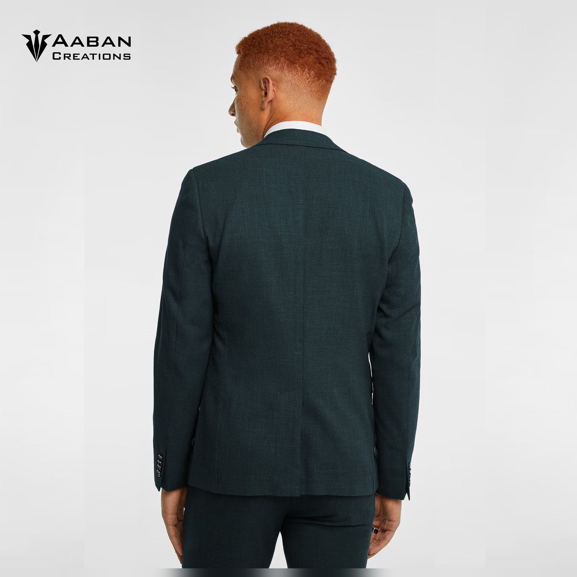 Man in a custom-made, jungle green two-piece suit from the back.