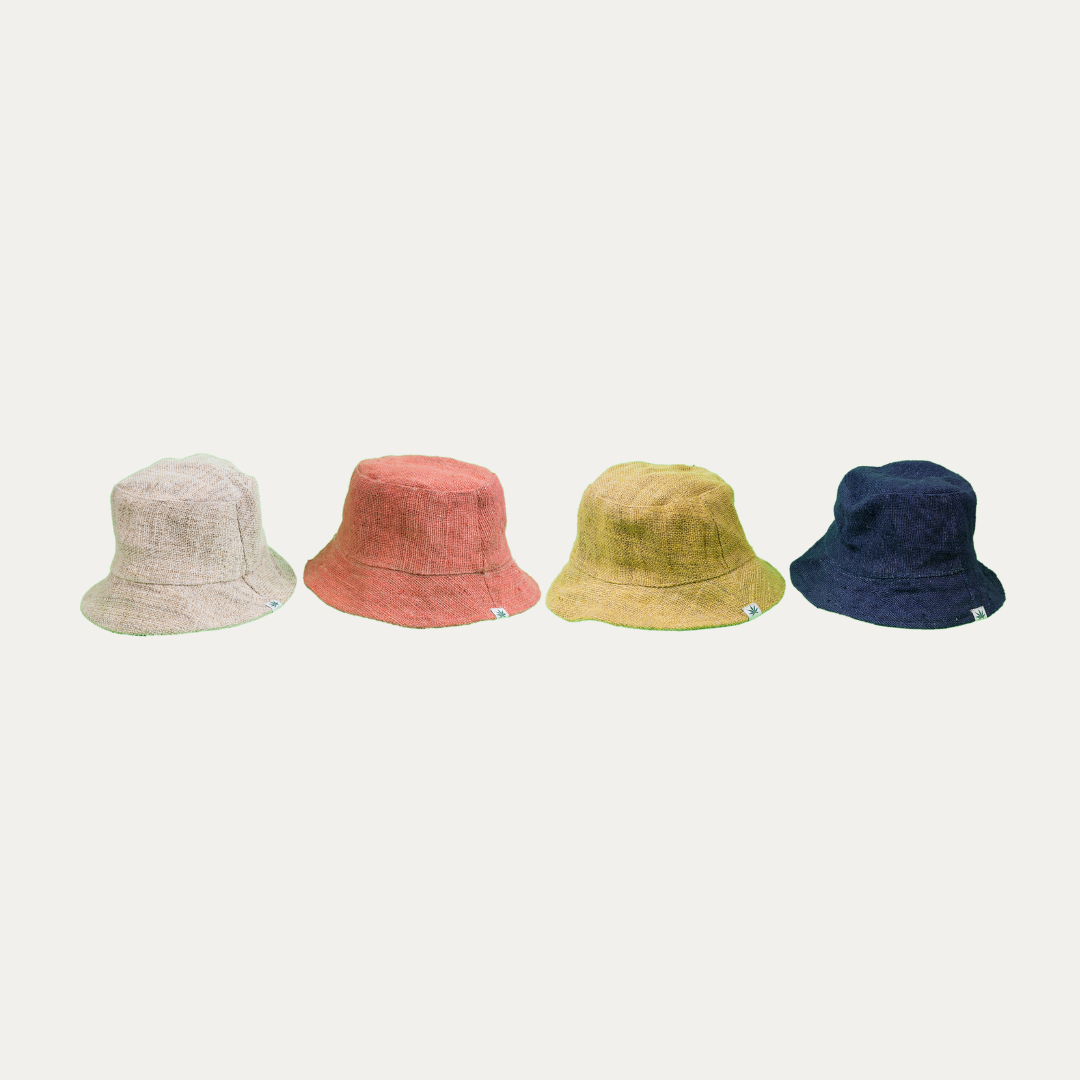 Four stylish hemp bucket hats in natural, rust, gold, and navy blue. Provides UV protection and easy airflow for comfortable wear.