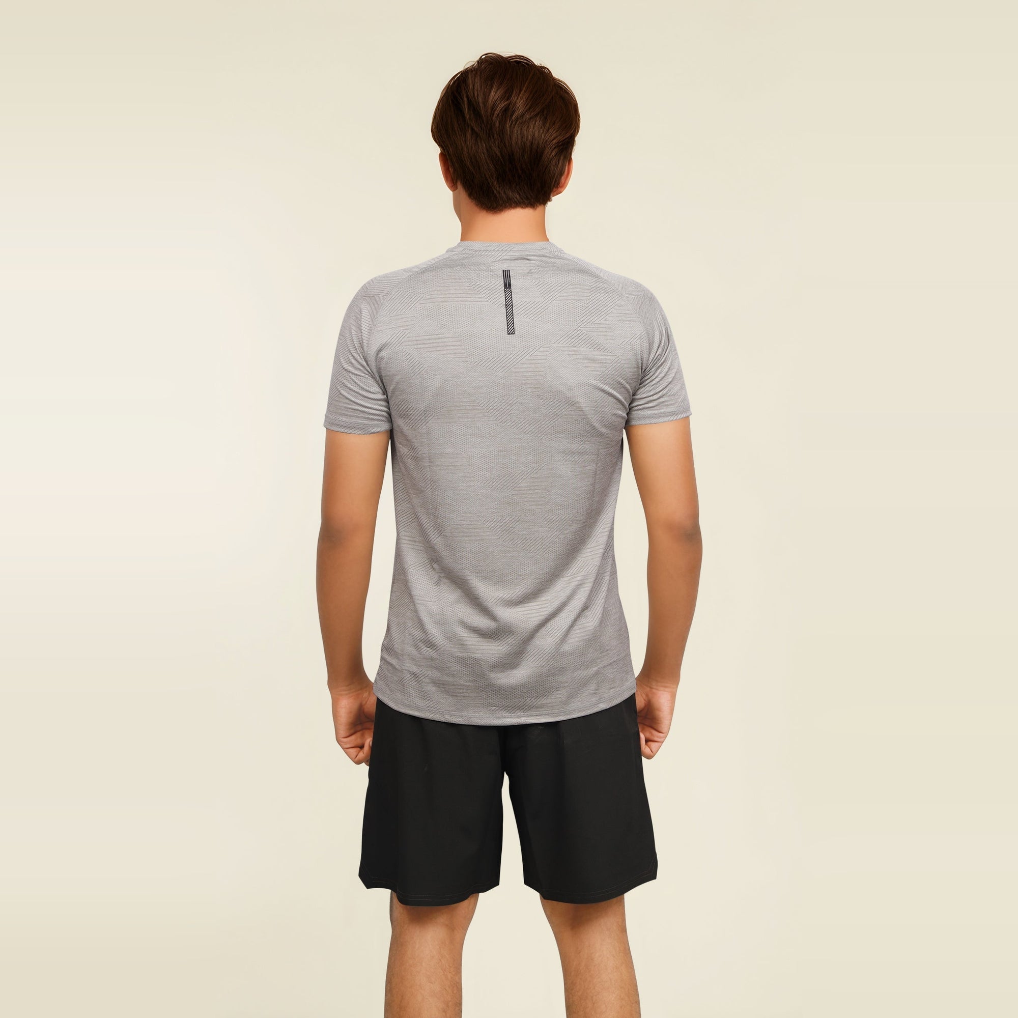 Man wearing a grey, short sleeve, dry fit, crew neck T-shirt from the back.