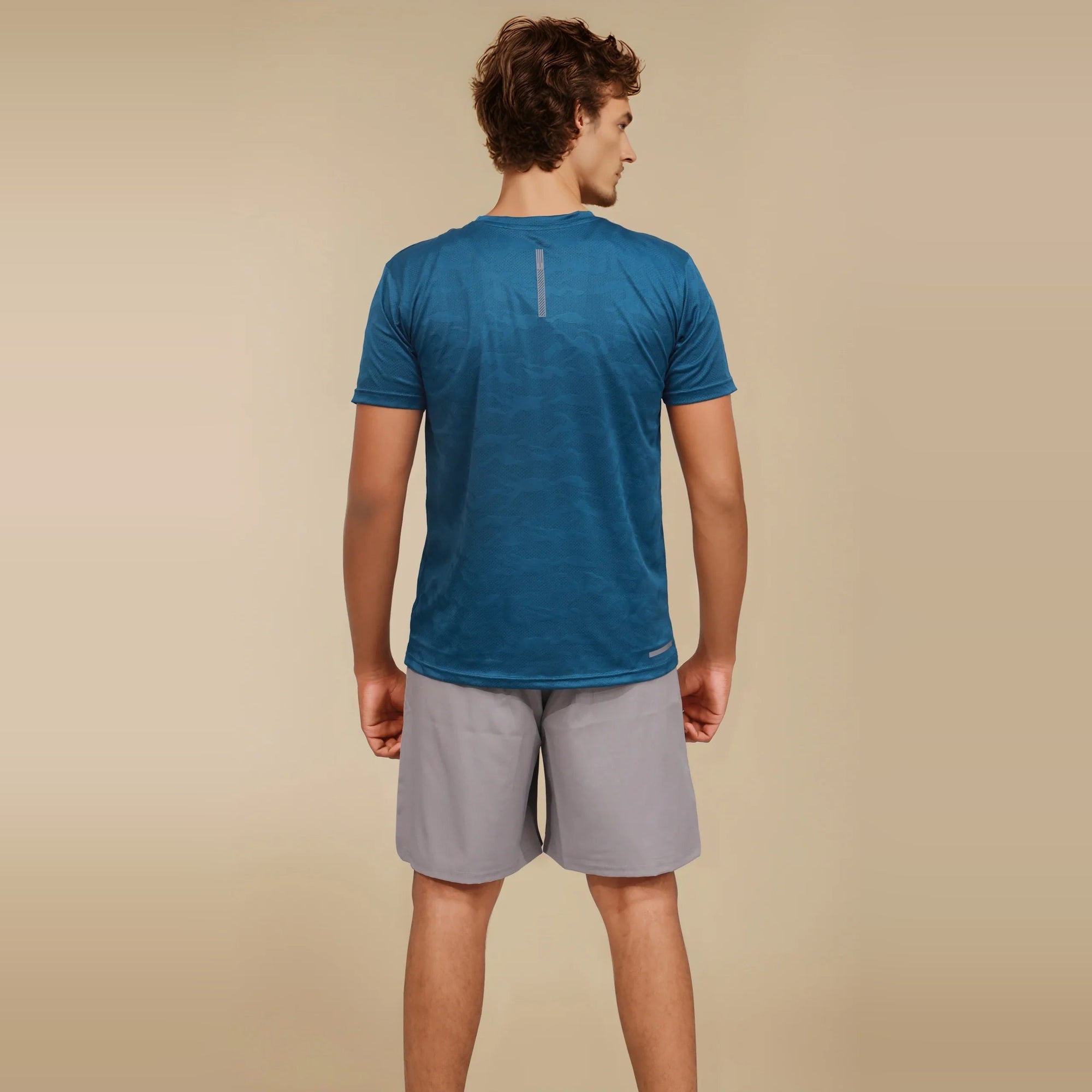 Man wearing a blue Dry-Fit crew neck t-shirt, ideal for workouts and staying cool during exercise.