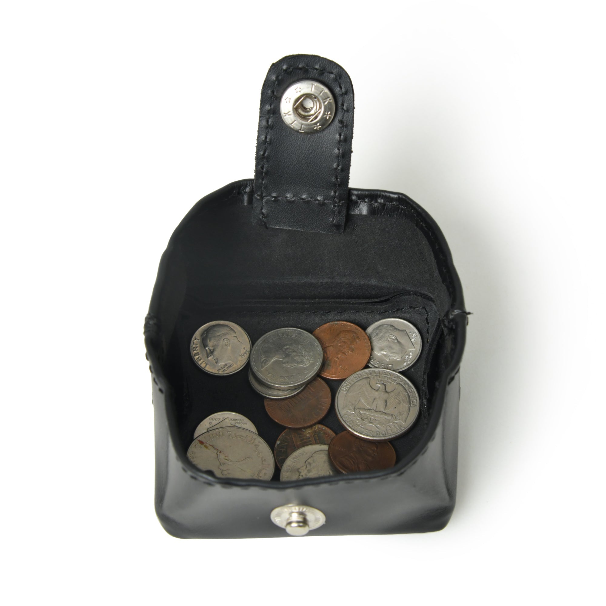 Black cherry leather coin purse open and filled with coins.