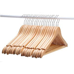 Set of smooth, natural finish wooden hangers on a clothes rail. Perfect for keeping clothes wrinkle-free.