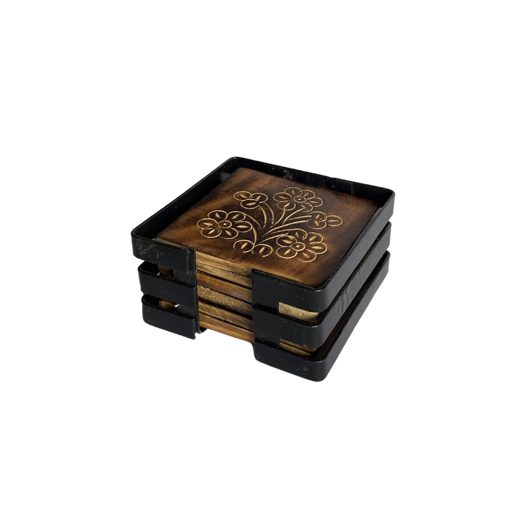 Set of square wooden coasters with floral etching, neatly stored in a black metal holder.