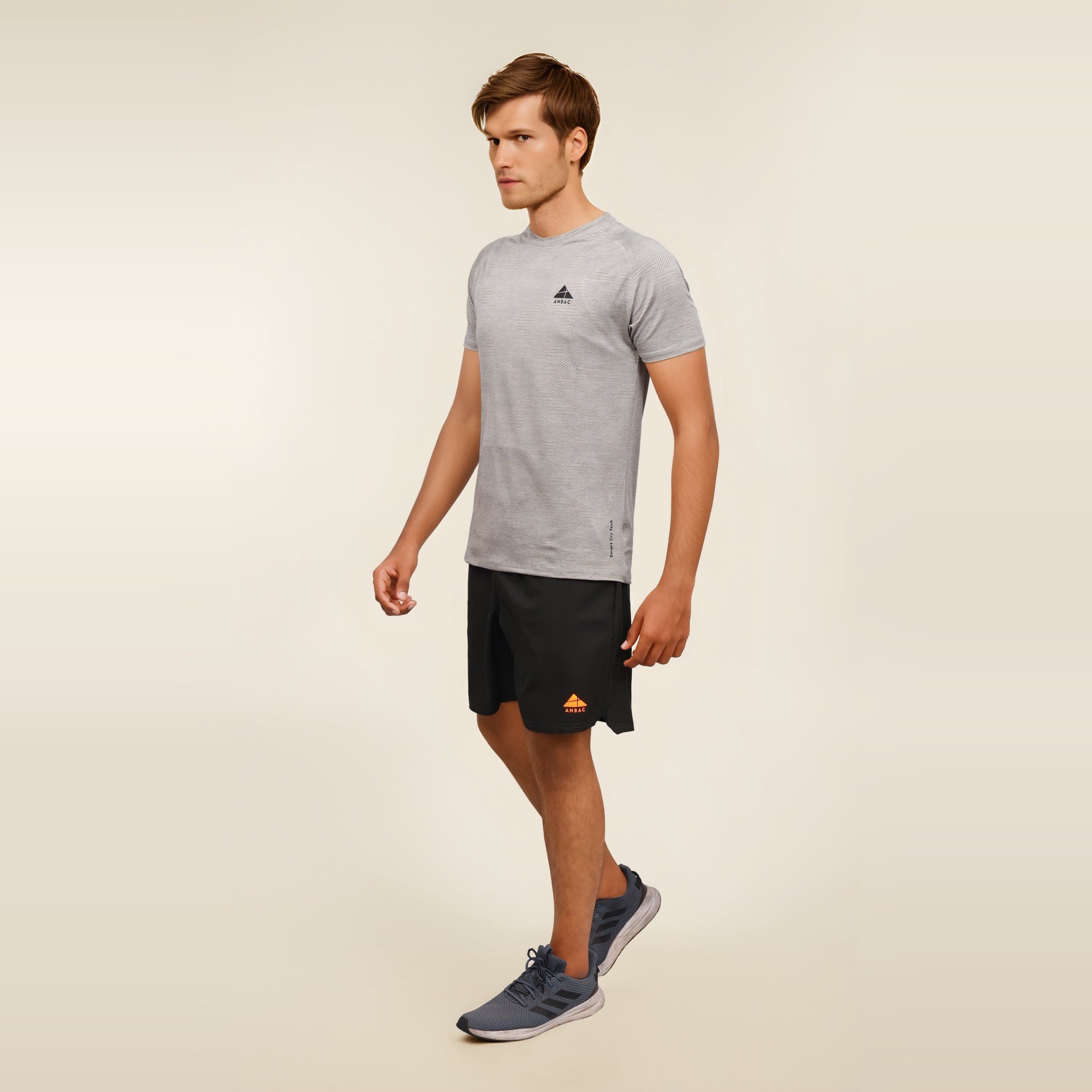 Man wearing a grey, short sleeve, dry fit, crew neck t-shirt.