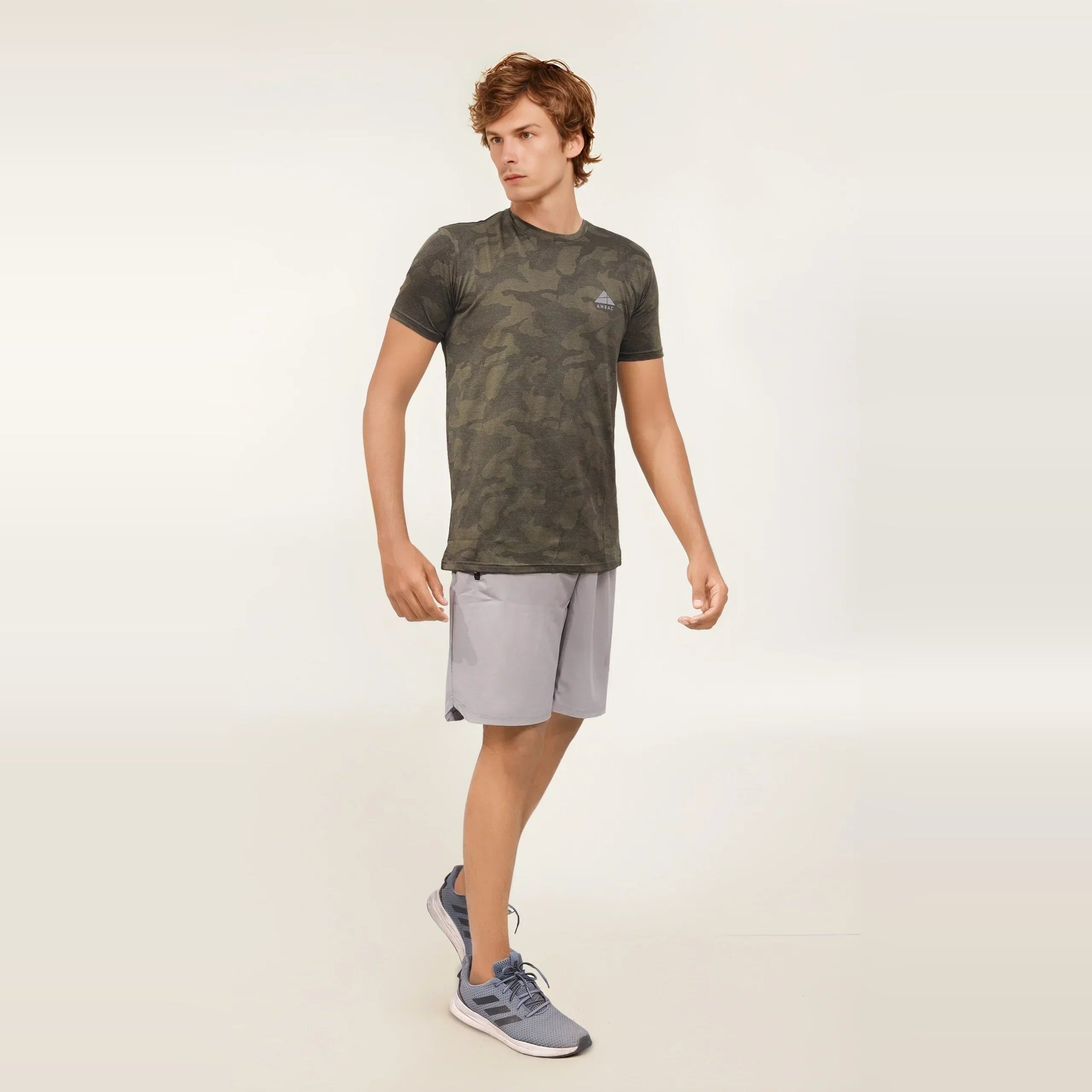 Man wearing a green camouflage dry-fit crew neck t-shirt perfect for workouts.