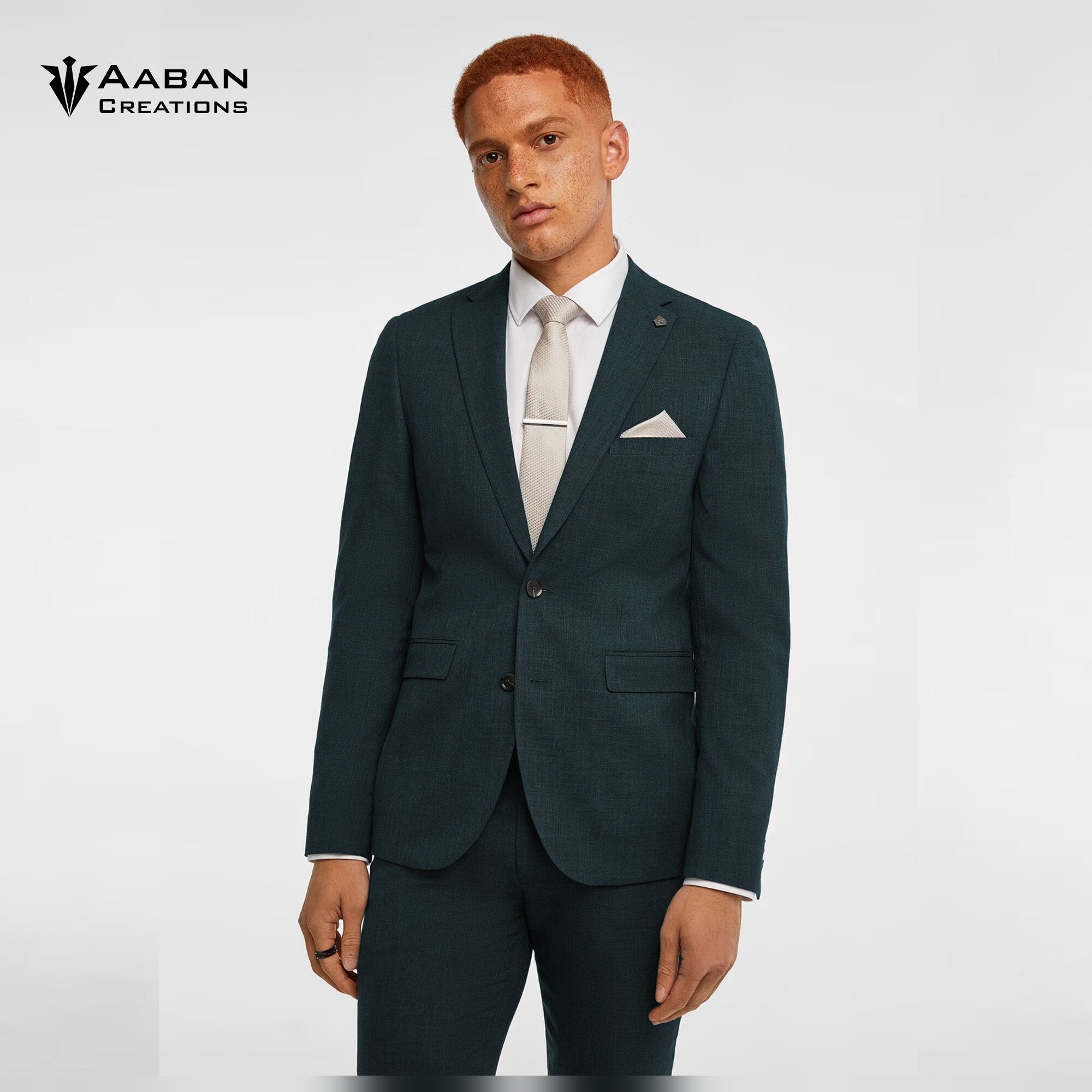 Man in a stylish, jungle green two-piece suit perfect for formal occasions.