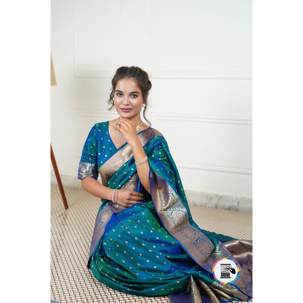 Woman wearing a blue printed Banarasi tissue silk saree with intricate gold border, showcasing its drape and elegant design.