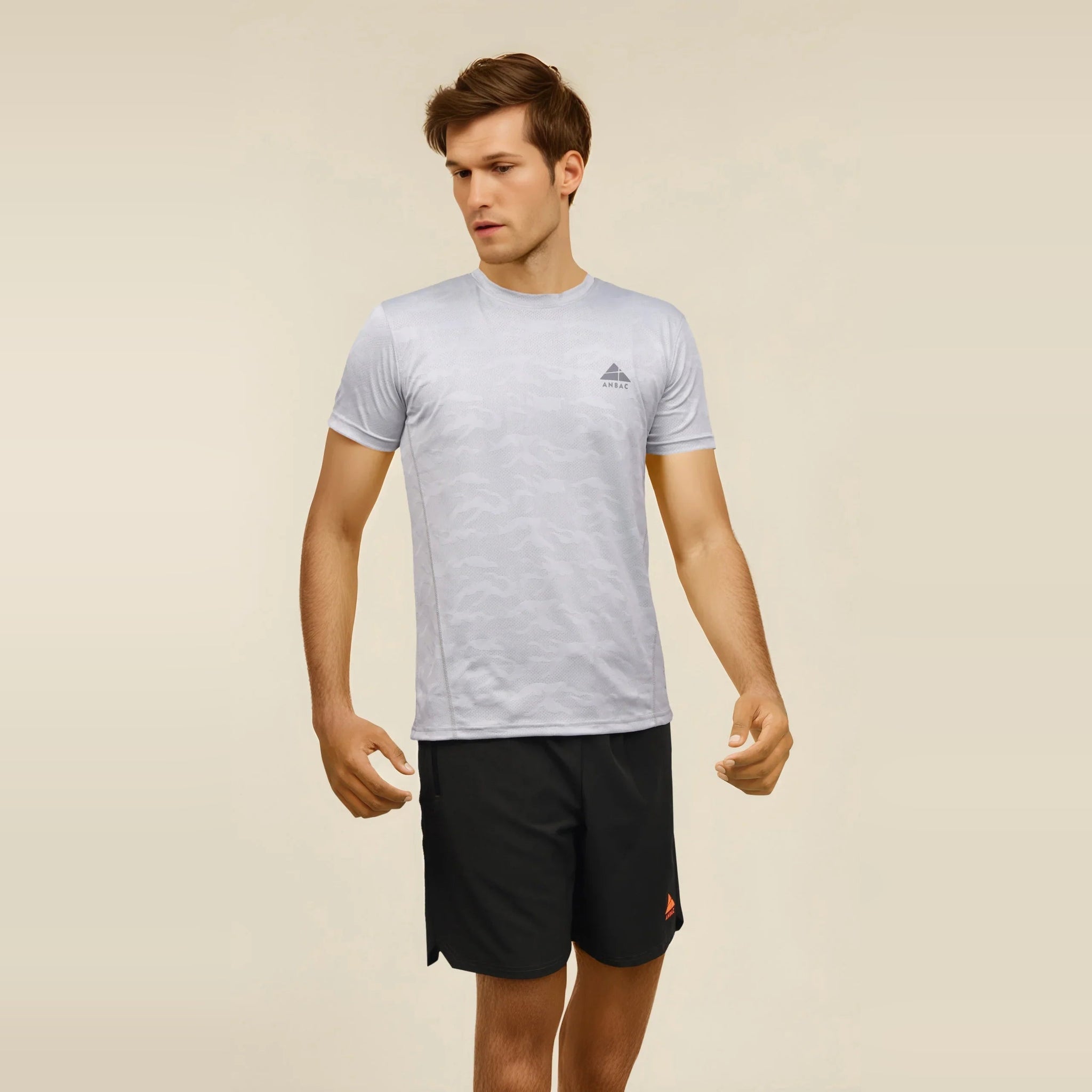 Man wearing a grey, crew neck, dry-fit T-shirt for men, ideal for workouts.