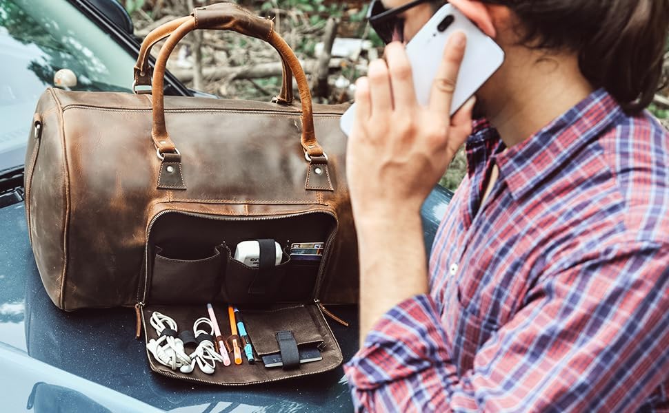 Stylish brown leather "Paris Weekender" duffel bag open on car, showcasing multiple pockets for easy organization.