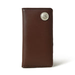 A sleek, brown leather checkbook cover stands closed, showcasing its slim profile and a silver-tone concho detail.