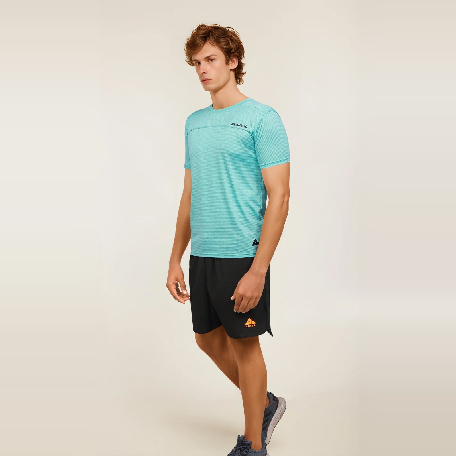 A man models a turquoise Men's Casual Slim Fit Short Sleeve T-Shirt, perfect for a relaxed and stylish look.