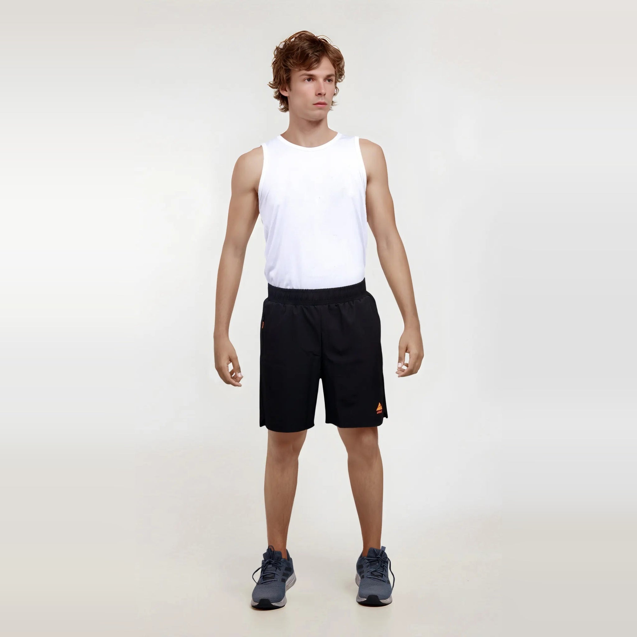 Man modeling black Regular Fit Shorts, designed to be wrinkle-free and dry-fit for sports and gym wear.