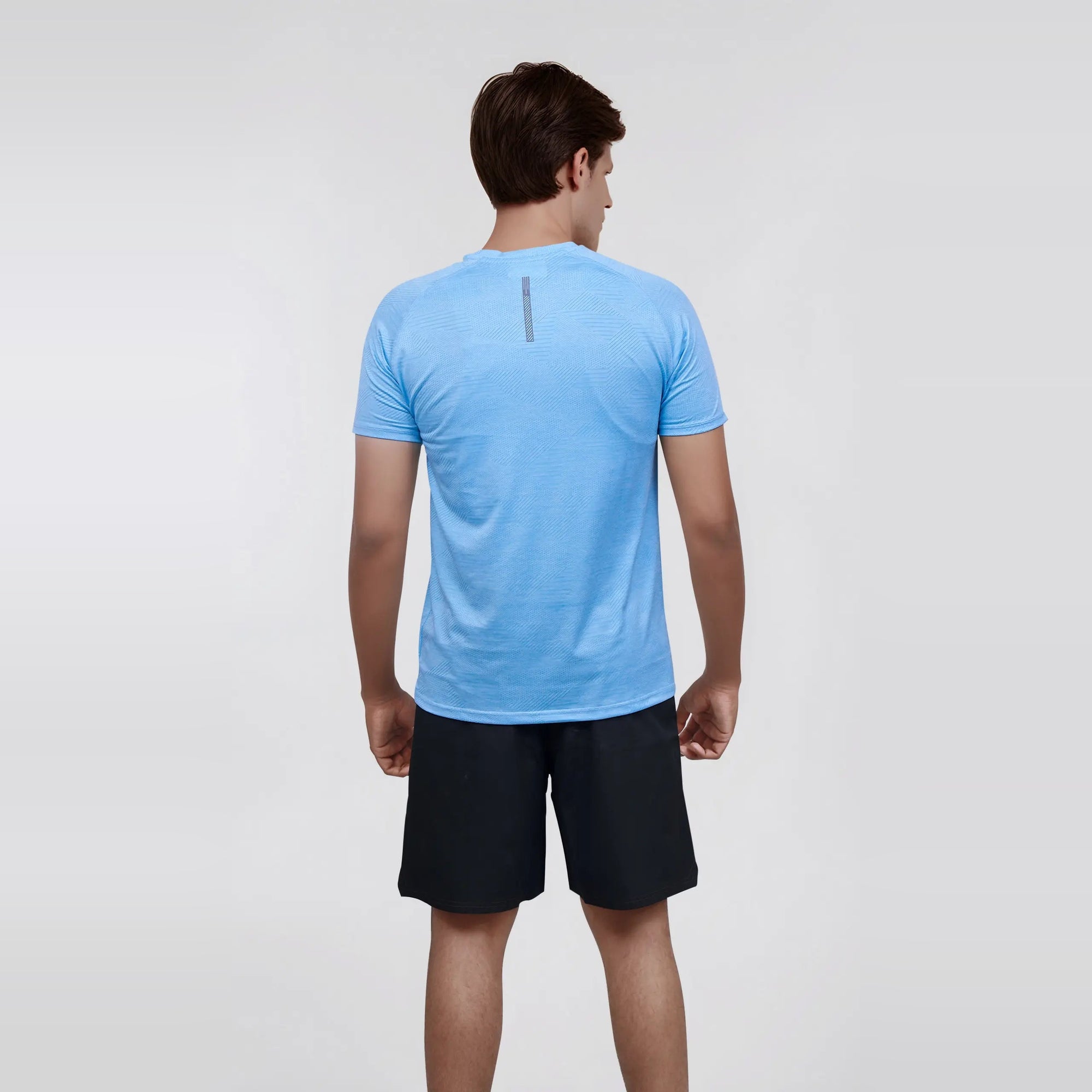 Man wearing a blue, short sleeve, dry fit, crew neck t-shirt.