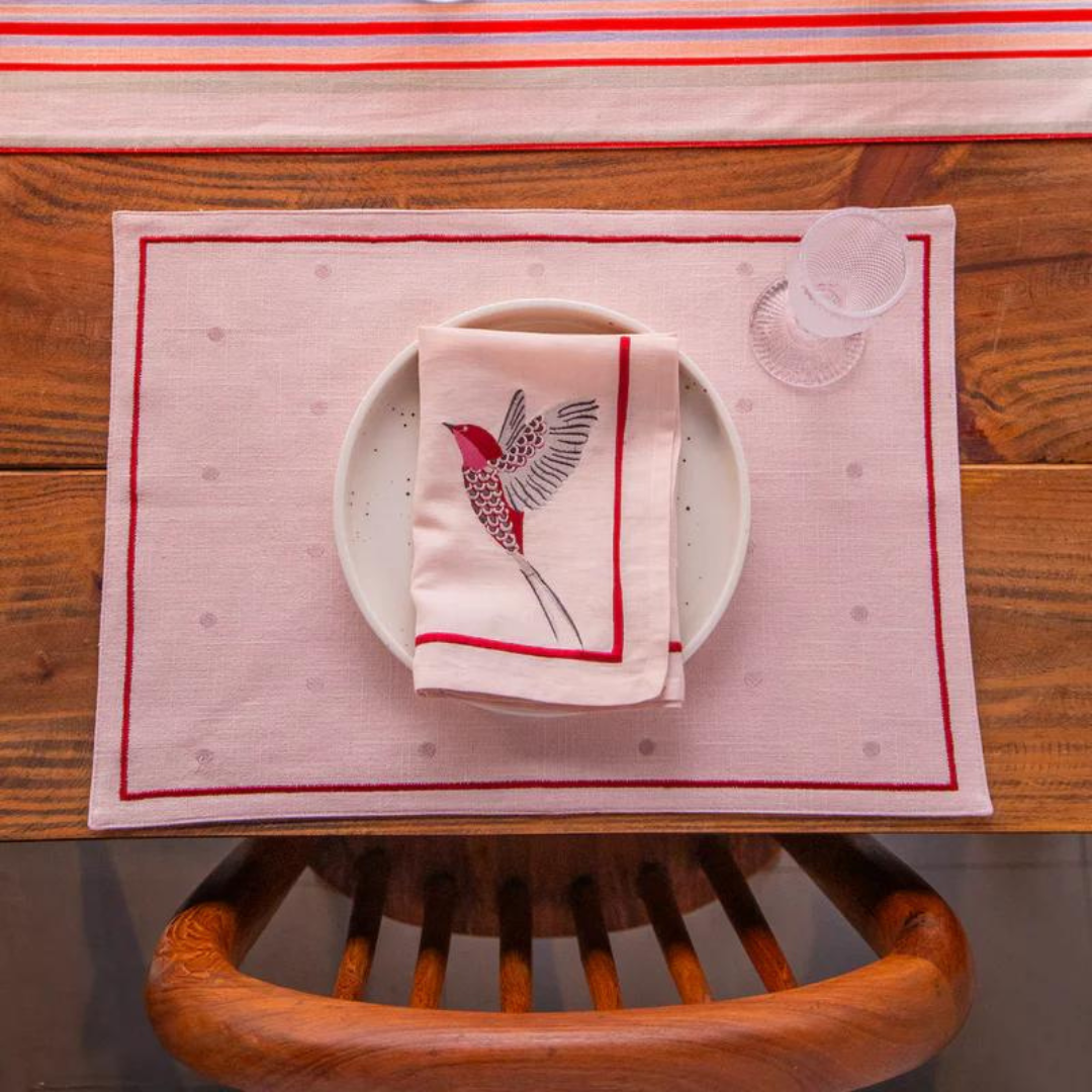 Scarlet French linen set with a pink hummingbird design, including six placemats, six napkins, and one table runner.