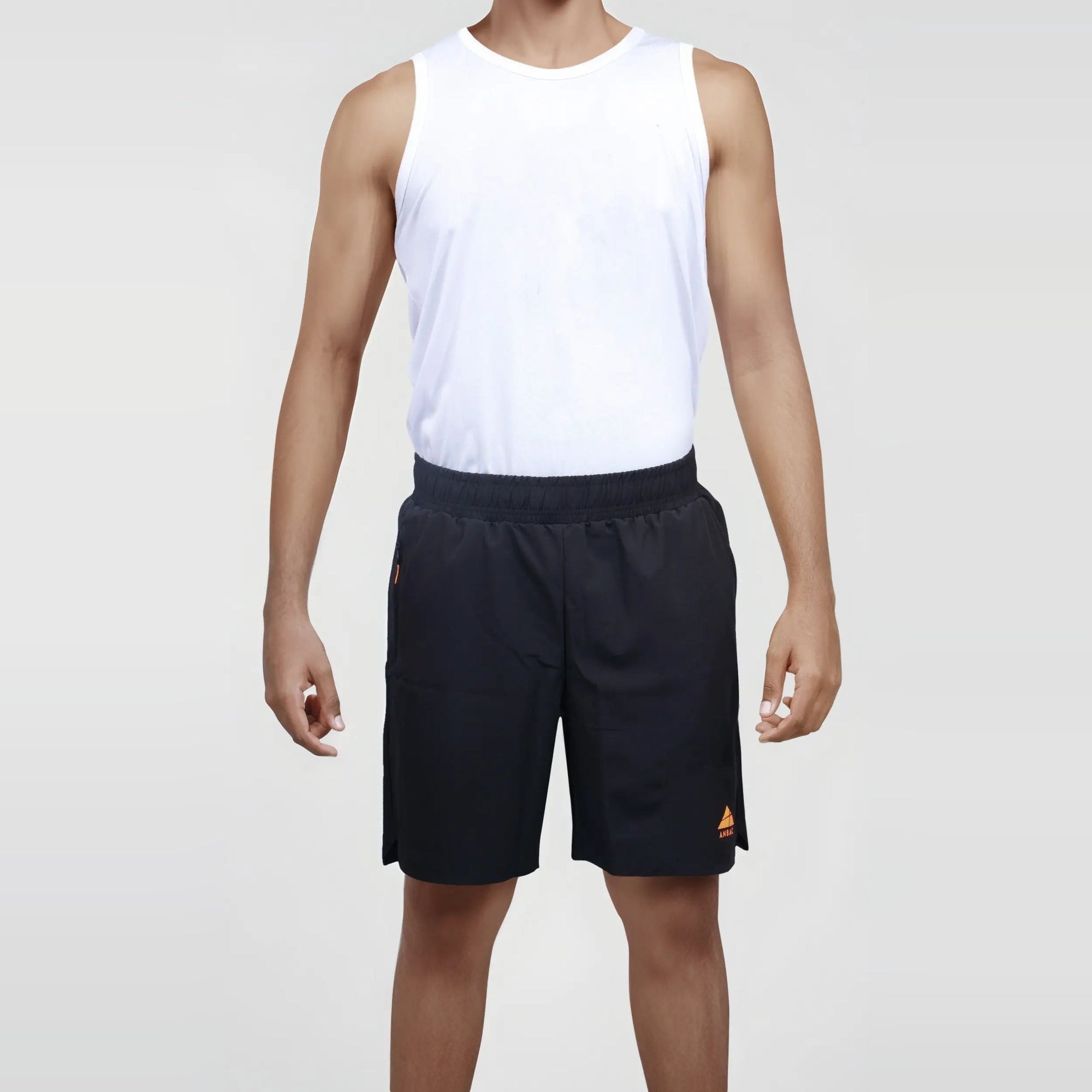 Man wearing black wrinkle-free, dry-fit shorts, ideal for sports and the gym.