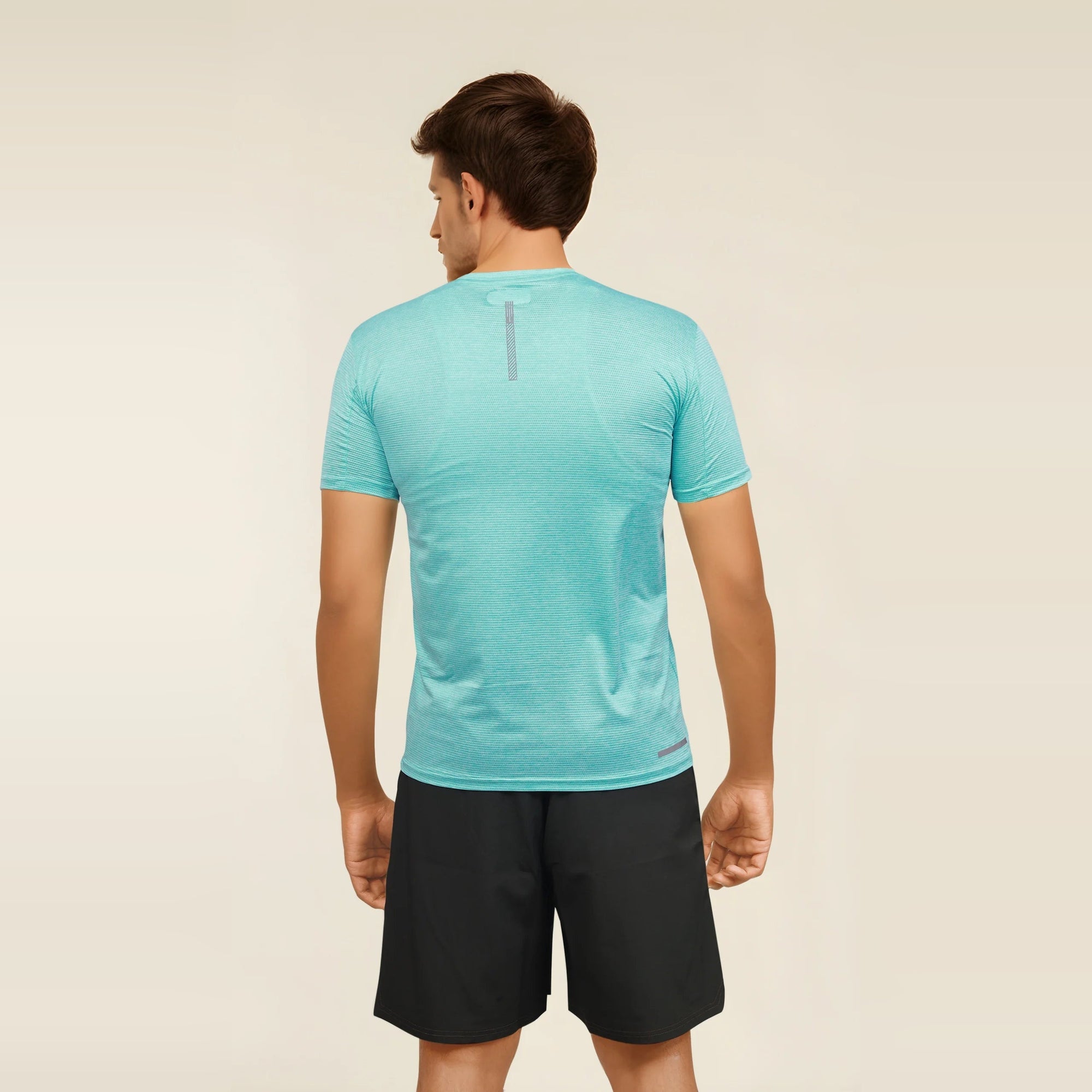 Man wearing a slim-fit, teal Men's Casual Slim Fit Short Sleeve T Shirt, showcasing the back view.