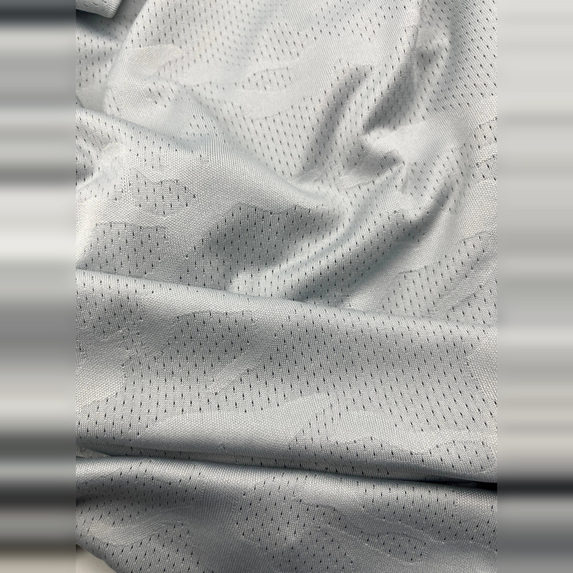 Close-up of breathable, gray Dry-Fit fabric. Ideal for workouts and staying cool.