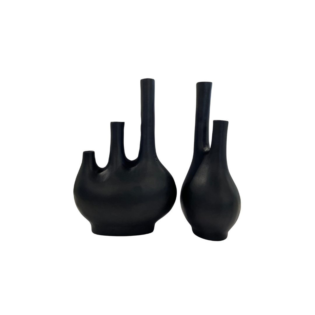 Two matte black vases with a unique three-neck design, perfect for modern and minimalist decor.