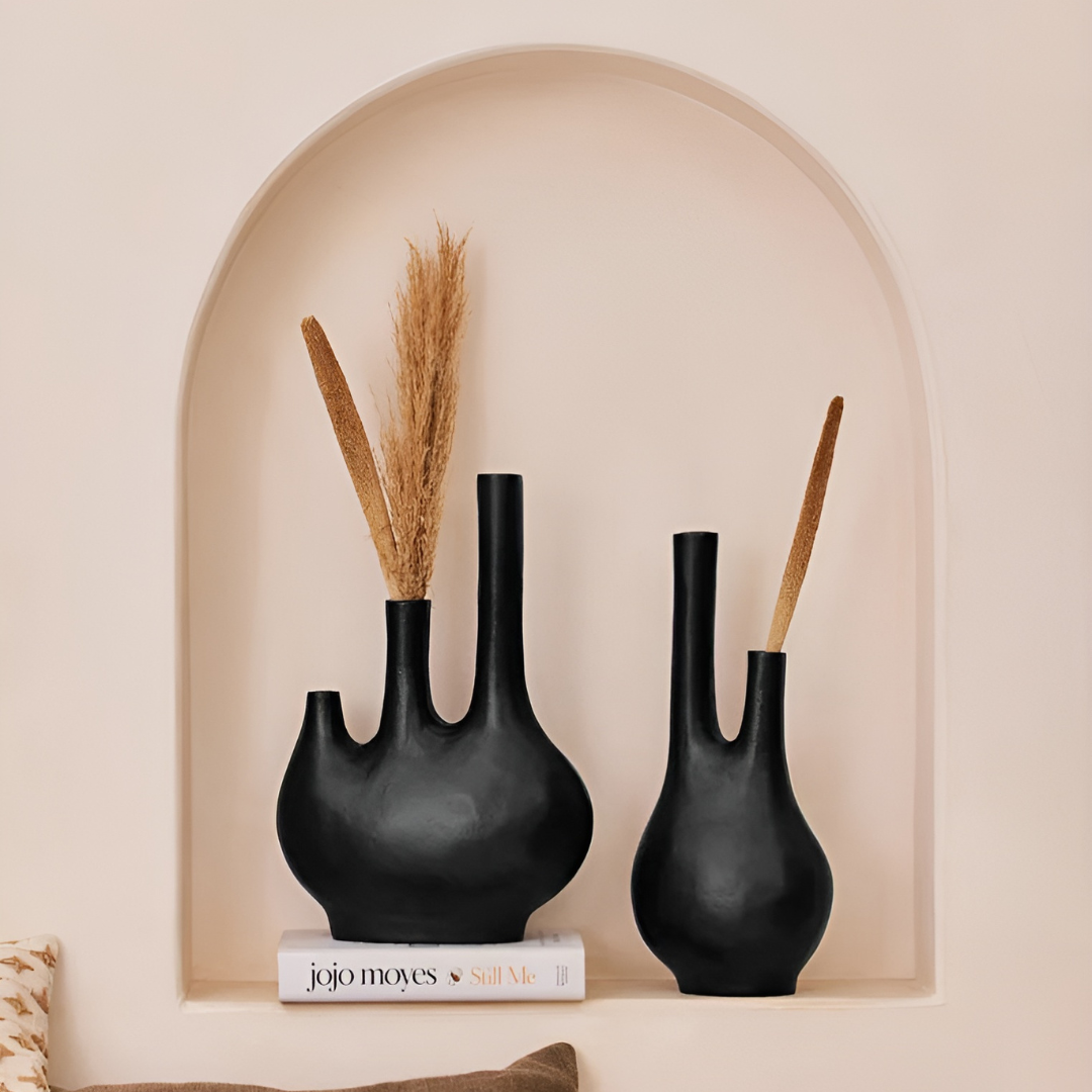 Stylish matte black metal vase with three necks, perfect for minimalist or modern decor. Anti-slip base for added stability.