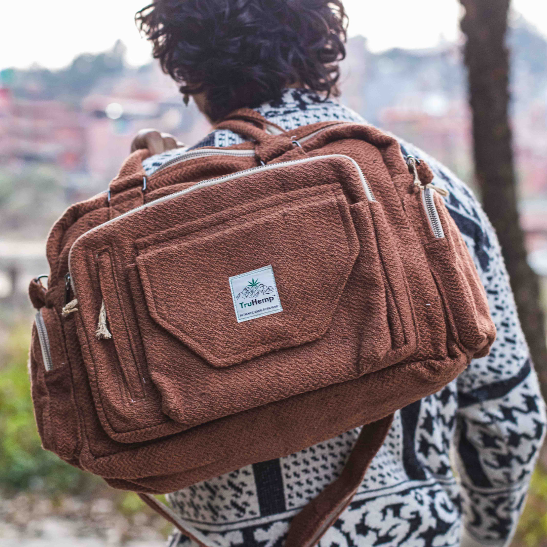 Stylish brown Himalayan Hemp Laptop Side Bag with adjustable strap, worn by a person outdoors.