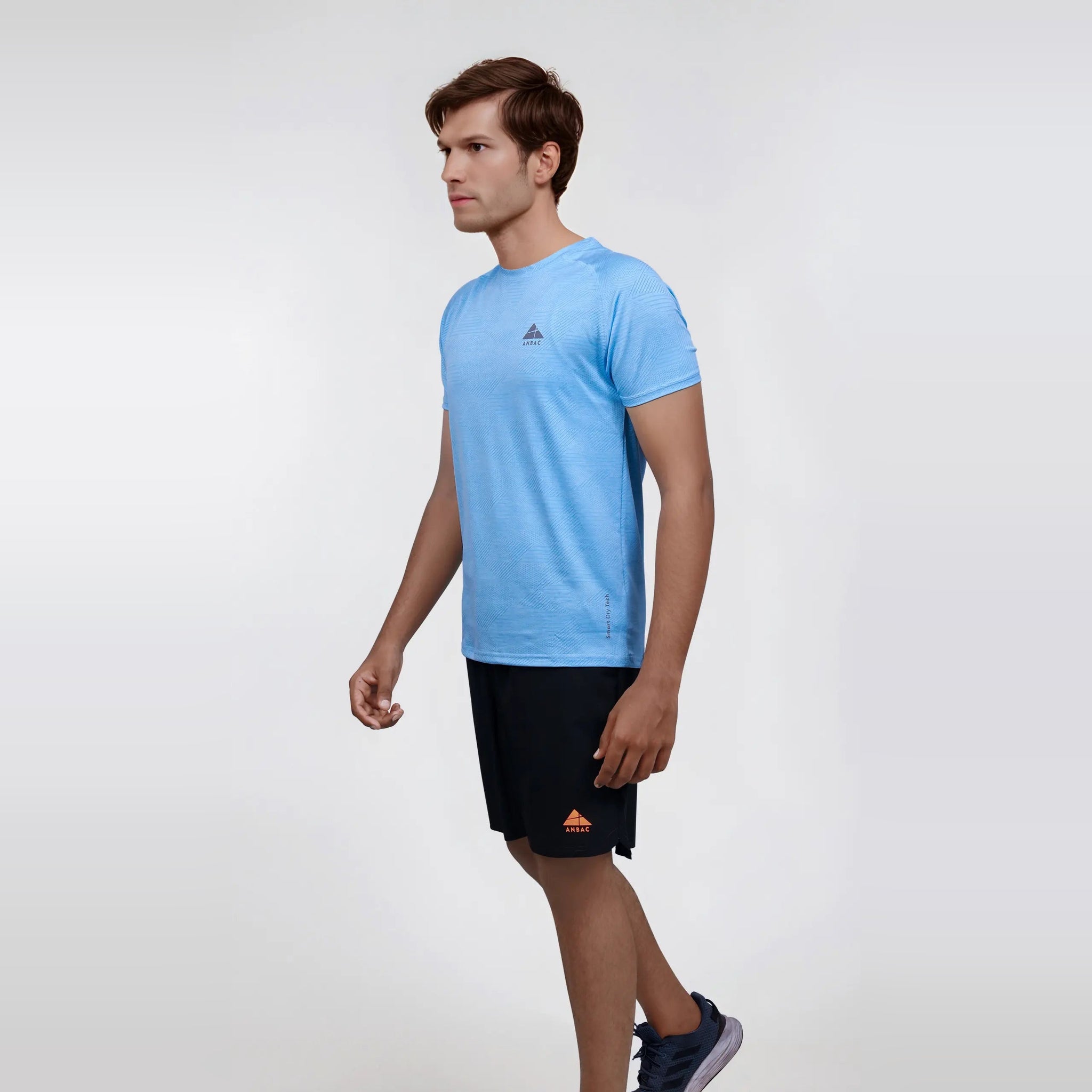 Man wearing a light blue, short sleeve, dry fit, crew neck t-shirt.