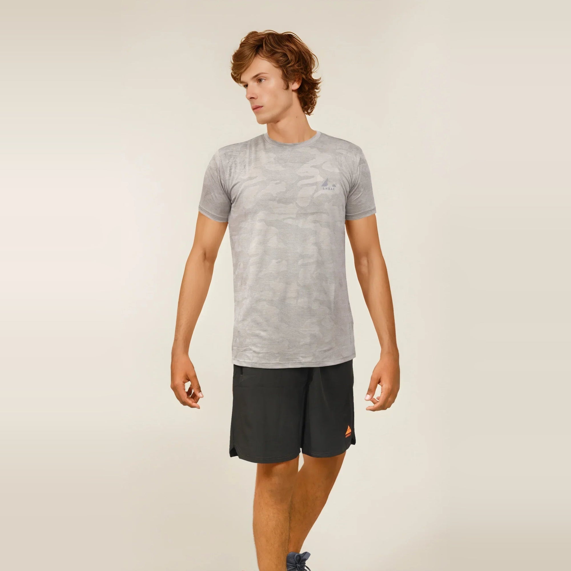 Man wearing a gray camo, dry-fit, crew neck t-shirt, ideal for workouts and staying cool.