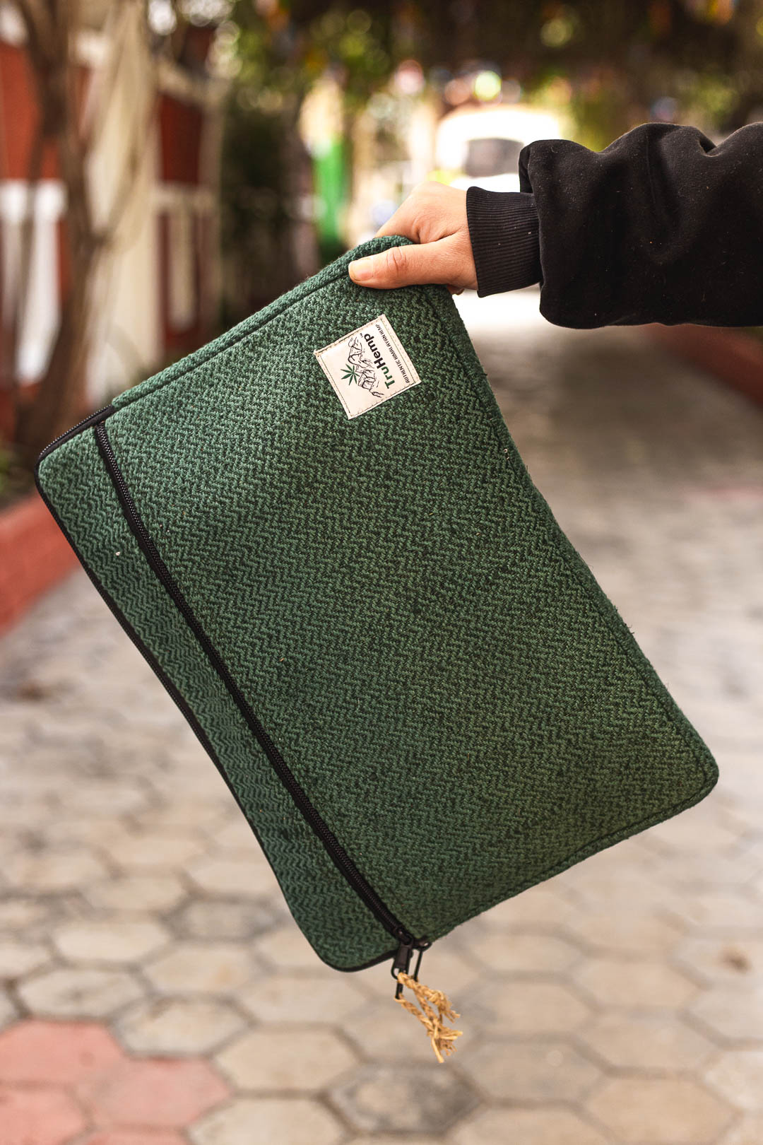 Eco-friendly Himalayan Natural Hemp Laptop Sleeve in a stylish green herringbone pattern. Perfect for protecting your device with a touch of natural elegance.