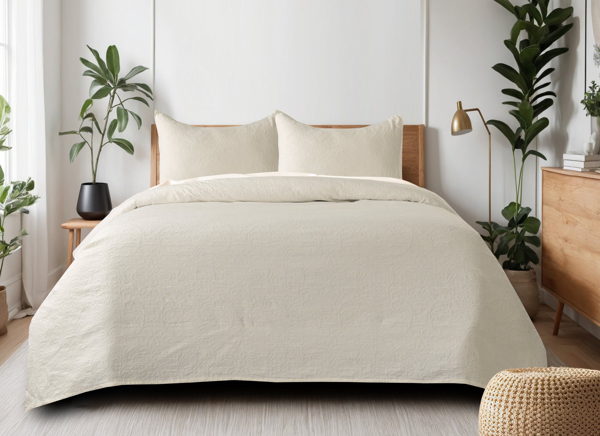 Cream-colored matelassÃƒÂ© cotton bedcover with a subtle floral pattern on a queen-size bed with two matching pillow shams.