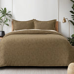 Sage green waffle-weave cotton bedsheet set with floral pattern on a queen-sized bed with two matching pillow shams.