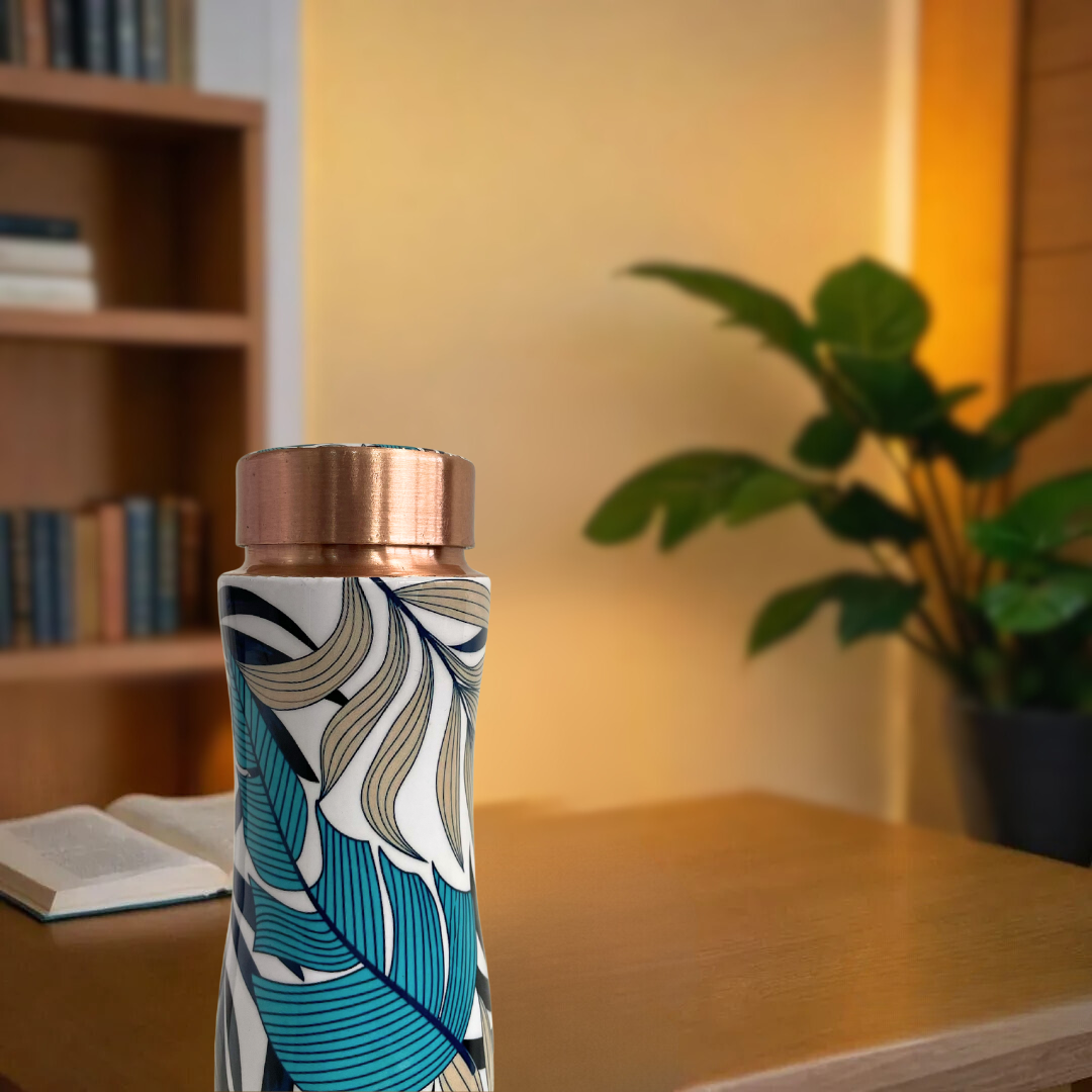 Leakproof 1 liter pure copper water bottle with a stylish leaf print, copper lid, and antibacterial properties.