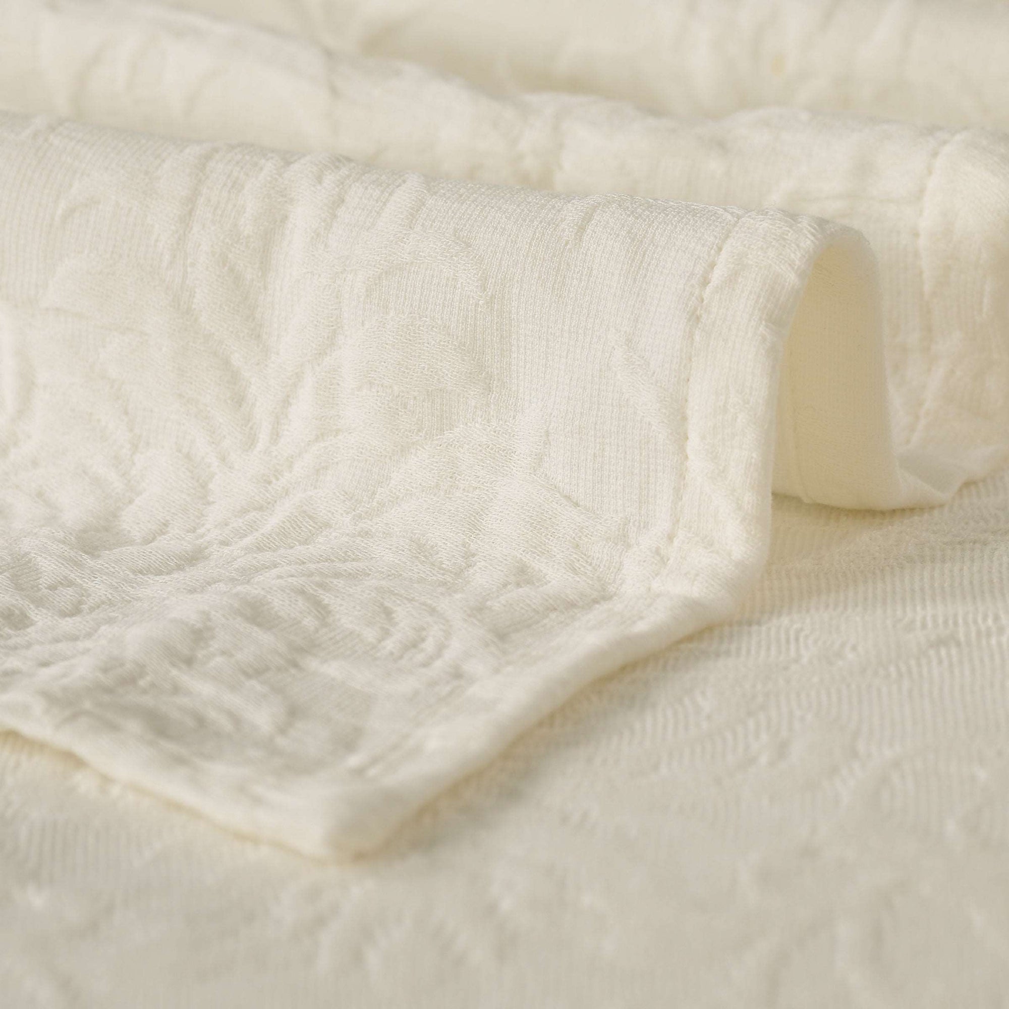 Close-up of the soft, textured cotton fabric of the Beautiful Blooms MatelassÃƒÆ’Ã‚Â¨ Bedcover. Includes two pillow shams.